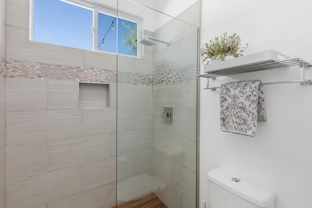 a bathroom with a double vanity sink toilet and shower