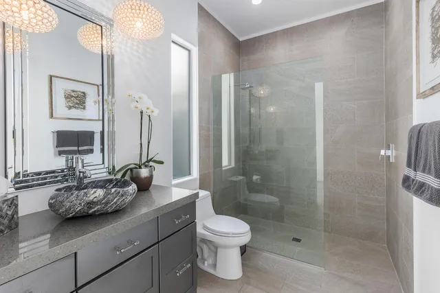 a bathroom with a double vanity sink toilet and a mirror