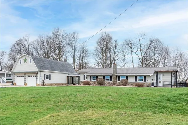 a front view of a house with a garden