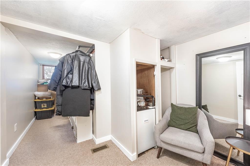 320 Deerfield Road Washington, PA 15301 - Photo 20 of 32 a living room with furniture a rug and a walk in closet