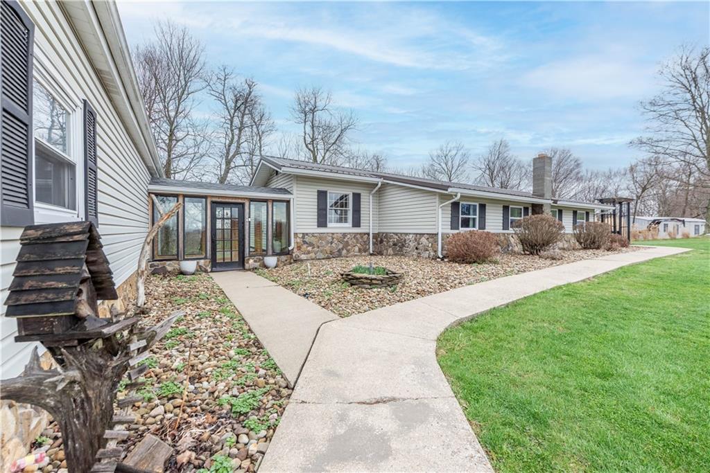 320 Deerfield Road Washington, PA 15301 - Photo 2 of 32 a front view of a house with a garden and trees