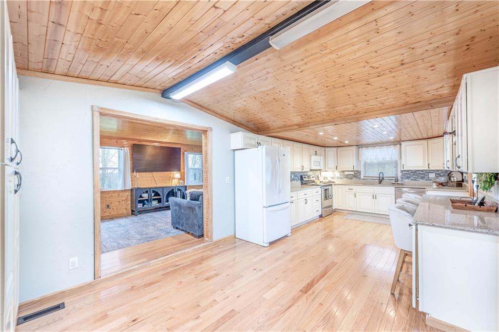 320 Deerfield Road Washington, PA 15301 - Photo 9 of 32 a large white kitchen with wooden floor and a refrigerator