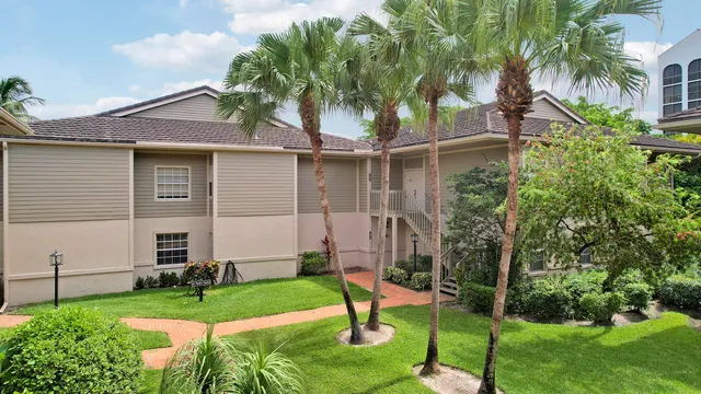 a front view of a house with a garden and plants
