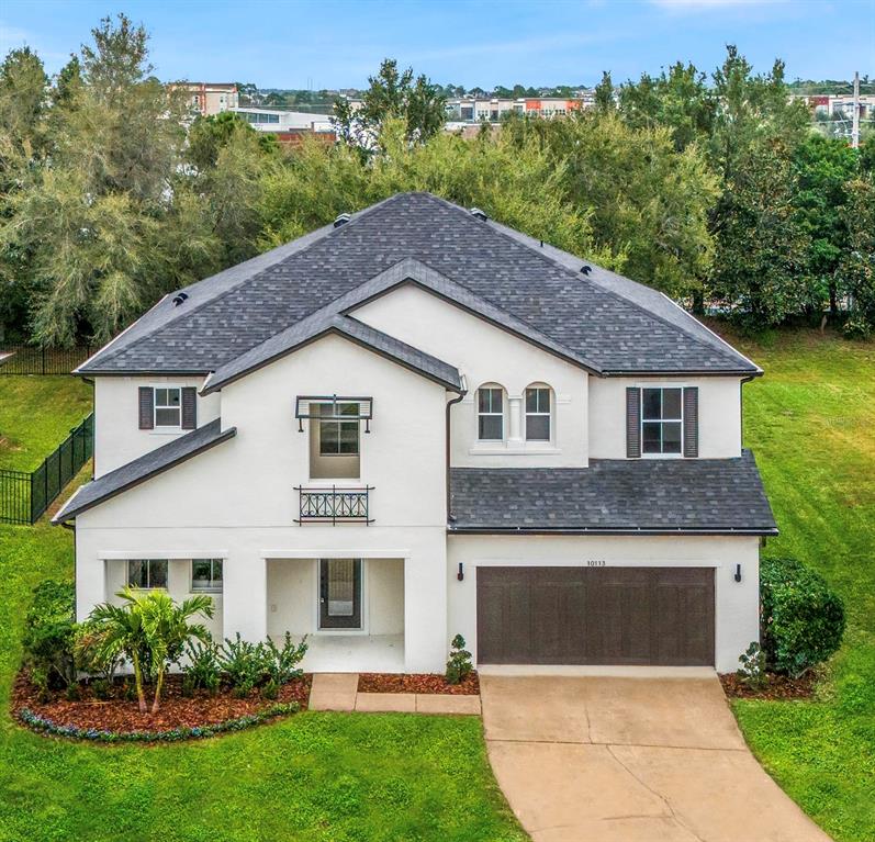 a front view of a house with a garden and plants