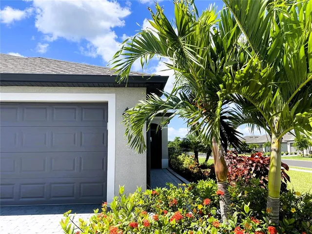 a kitchen with granite countertop white cabinets and a sink