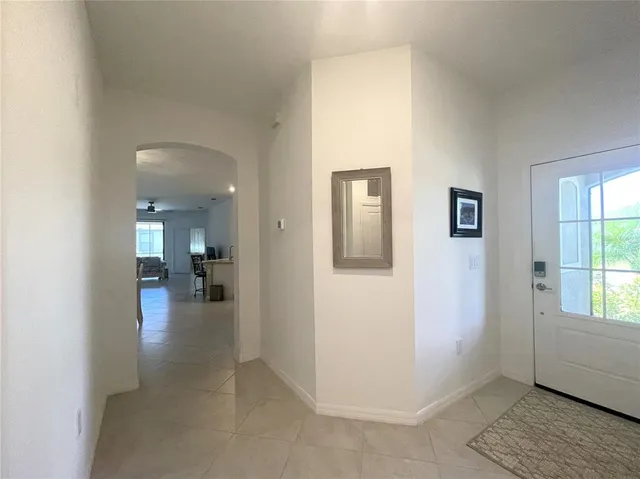 a view of a dining room with furniture and a chandelier
