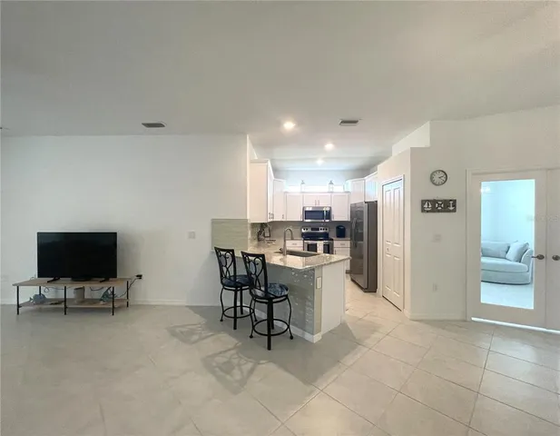 a view of a dining room with furniture and chandelier
