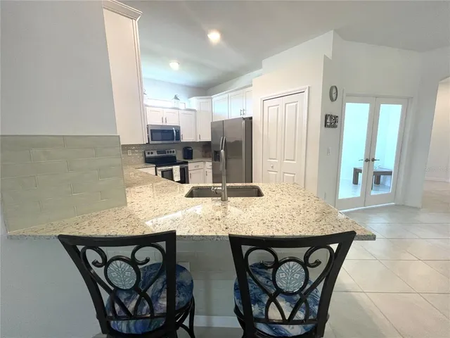 a view of a dining room with furniture and window