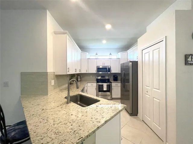 a view of a livingroom with furniture and a flat screen tv