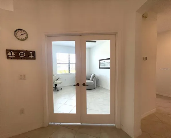 a white toilet sitting next to a white wall