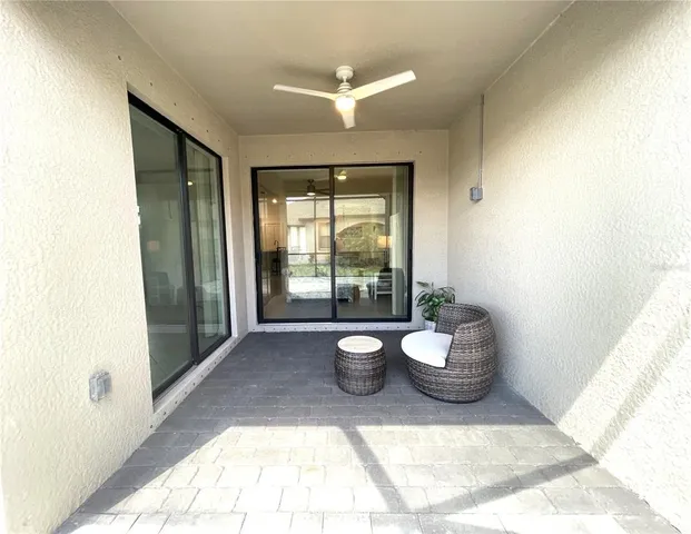 a view of a patio with a table and chairs under an umbrella