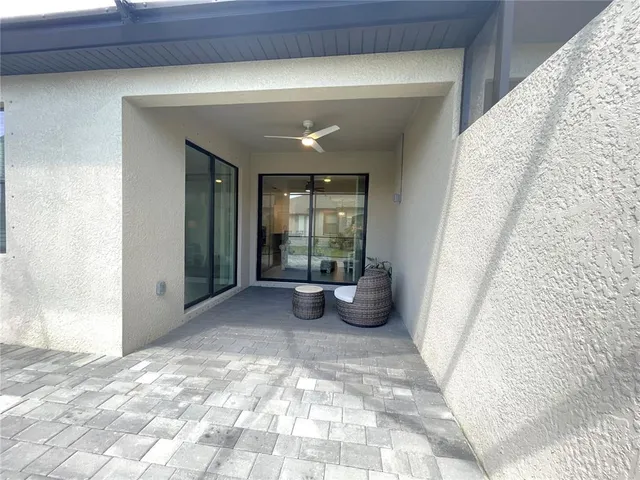 an aerial view of a house with swimming pool and patio