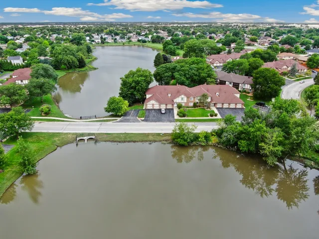 an aerial view of a house with a lake view