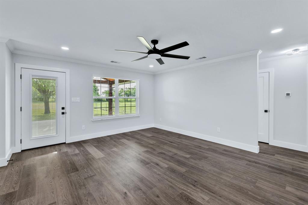 11345 Jennifer Circle Sanger, TX 76266 - Photo 13 of 39 a view of an empty room with wooden floor and a window