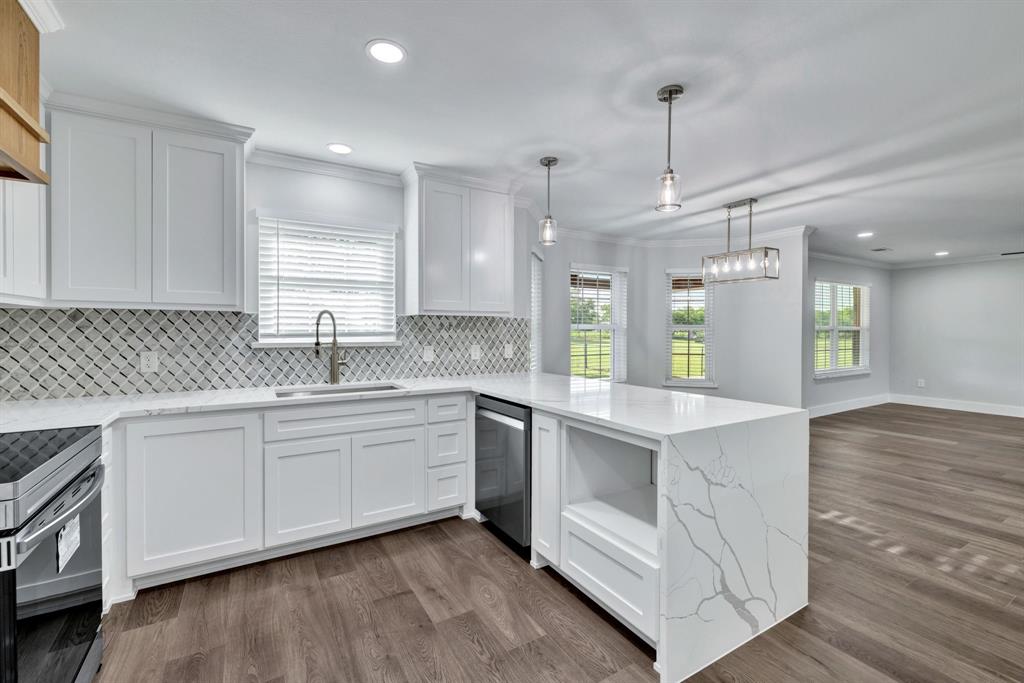 11345 Jennifer Circle Sanger, TX 76266 - Photo 22 of 39 a kitchen with white cabinets and sink
