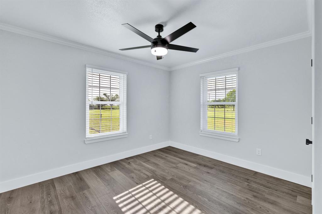 11345 Jennifer Circle Sanger, TX 76266 - Photo 23 of 39 a view of an empty room with a window and wooden floor