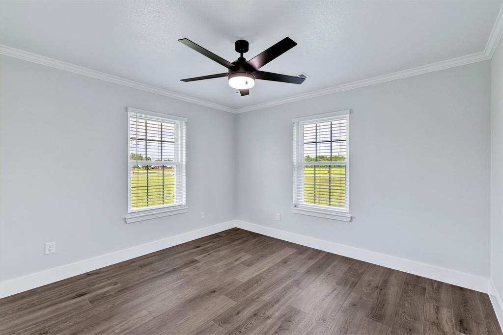 11345 Jennifer Circle Sanger, TX 76266 - Photo 26 of 39 a view of an empty room with wooden floor and a window