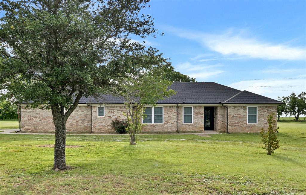 11345 Jennifer Circle Sanger, TX 76266 - Photo 6 of 39 a front view of a house with a garden