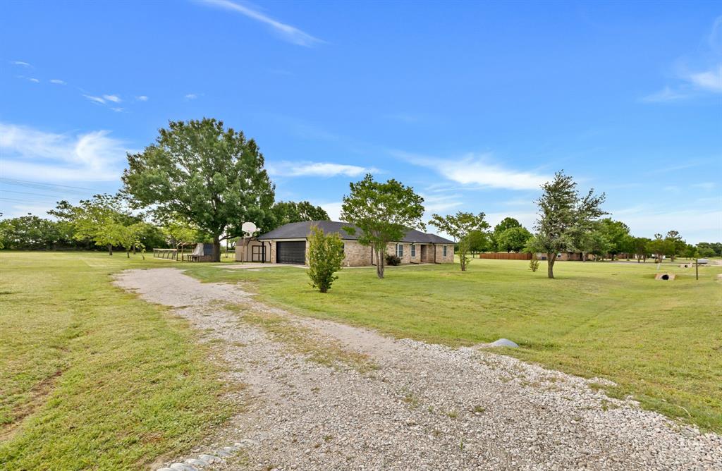 11345 Jennifer Circle Sanger, TX 76266 - Photo 9 of 39 a view of a house with a yard and basketball court