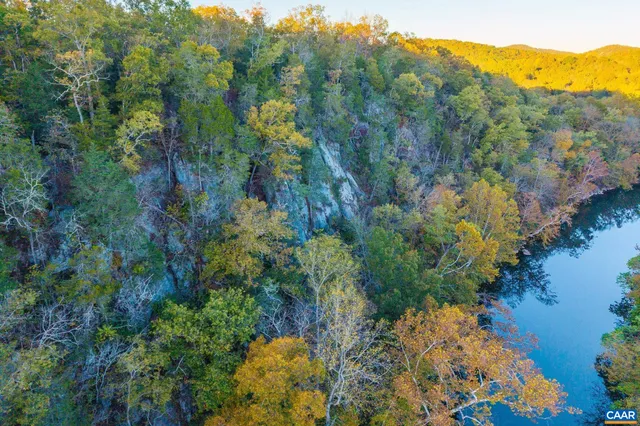 a view of a lush green hillside and houses