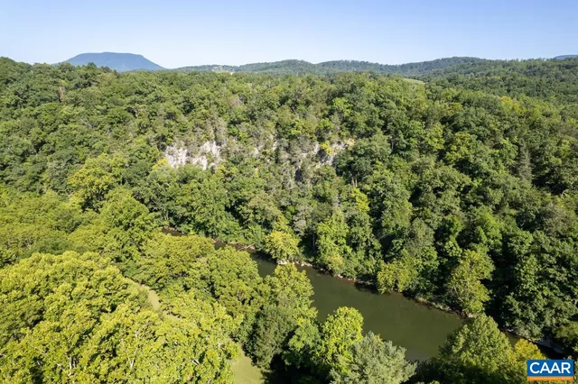 a view of a lush green hillside and a building