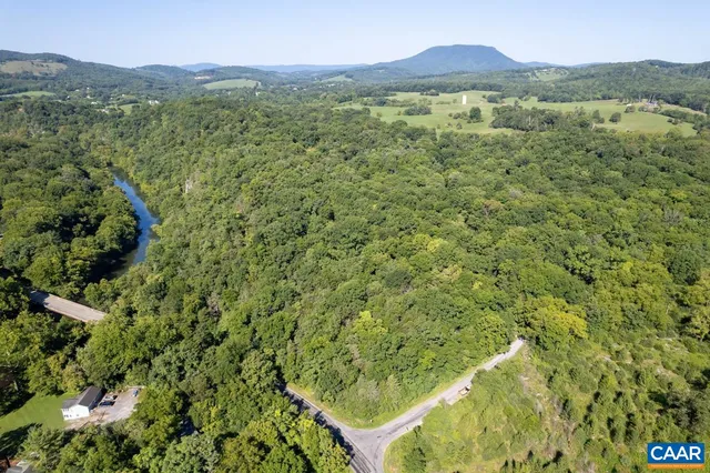 a view of a lush green hillside and a houses