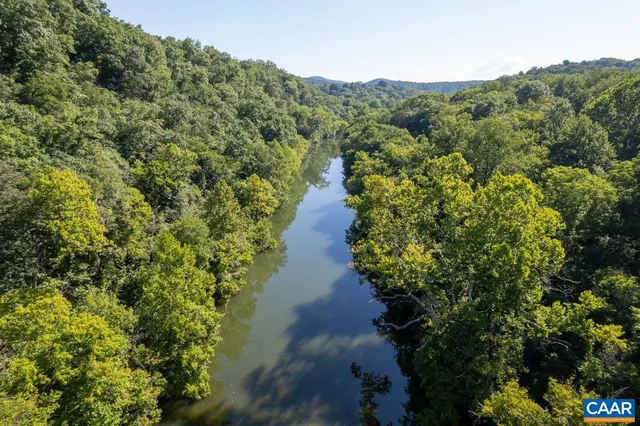 a view of a lush green hillside and a houses