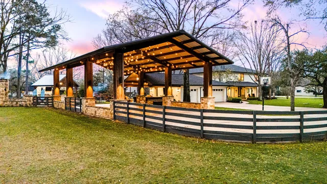 a backyard of a house with lots of green space and fountain