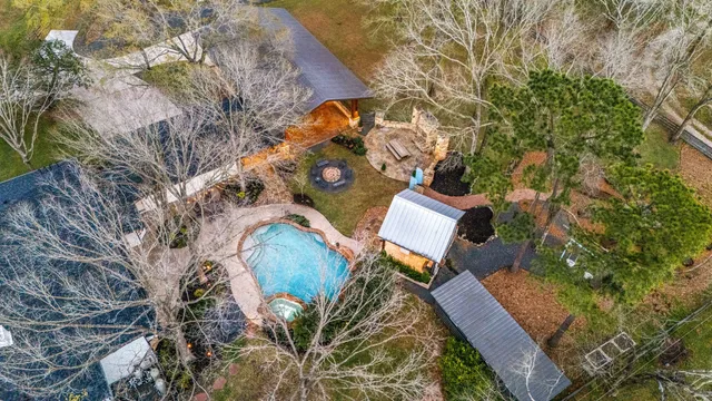 an aerial view of a house with outdoor space and a lake view