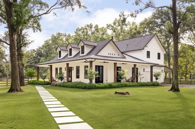 a front view of a house with a yard table and chairs