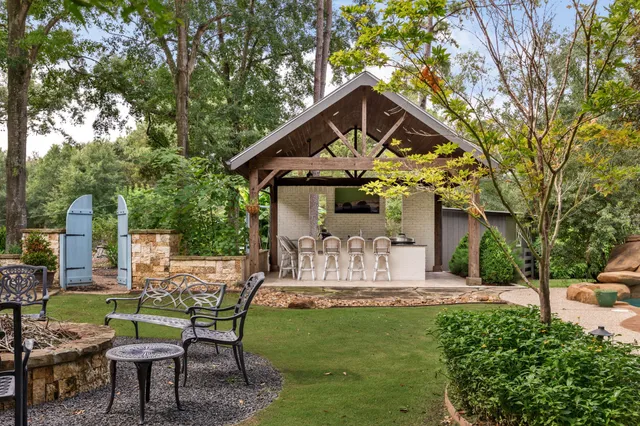a front view of a house with garden and sitting area