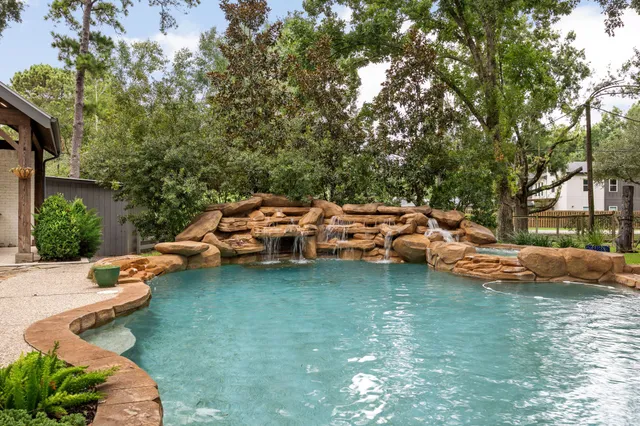 a view of a backyard with lawn chairs and a fire pit