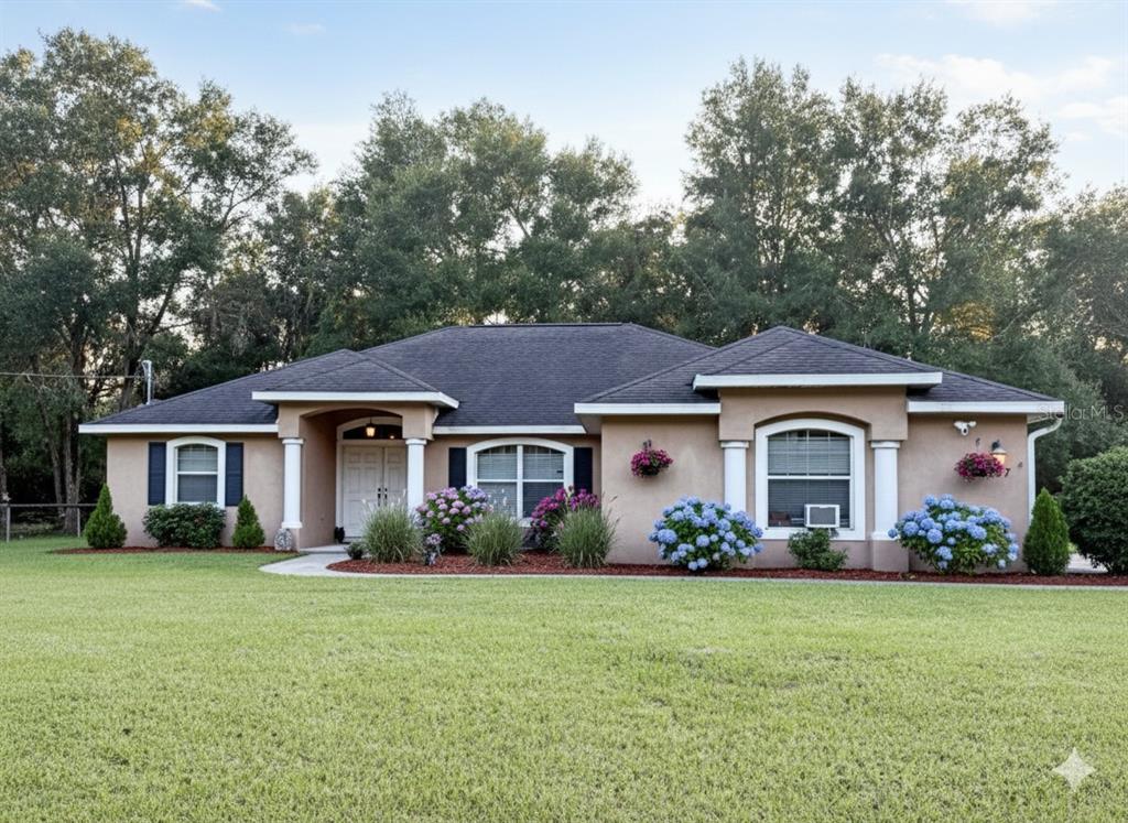a front view of house with yard and green space