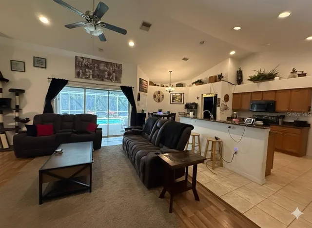 a living room with furniture and kitchen view