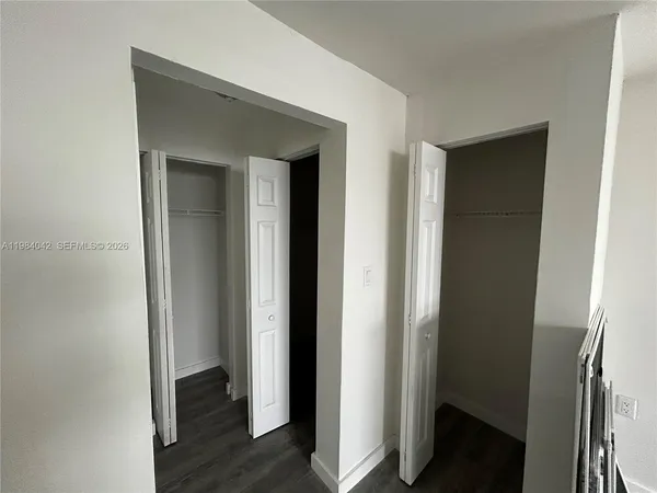 a view of a room with wooden floor and windows