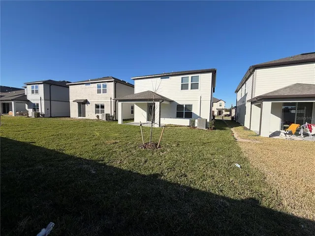 a view of a house with backyard and porch