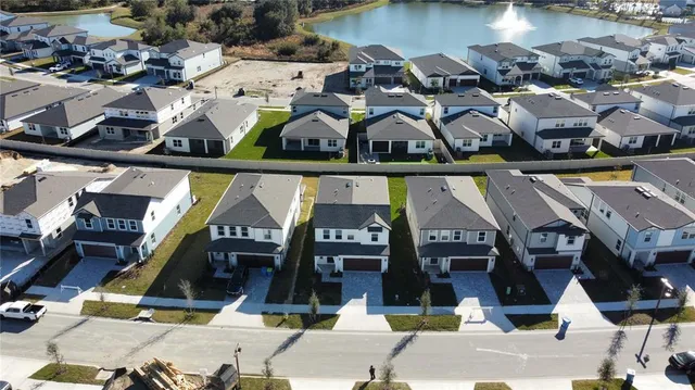 an aerial view of multiple houses with street