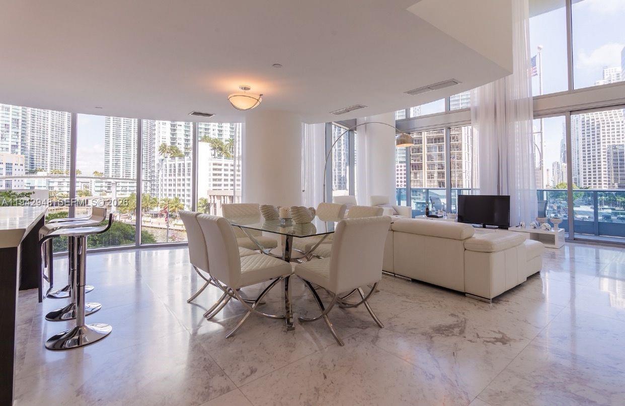200 Biscayne Blvd Way, Unit 502 Miami, FL 33131 - Photo 11 of 23 a living room with furniture and floor to ceiling windows