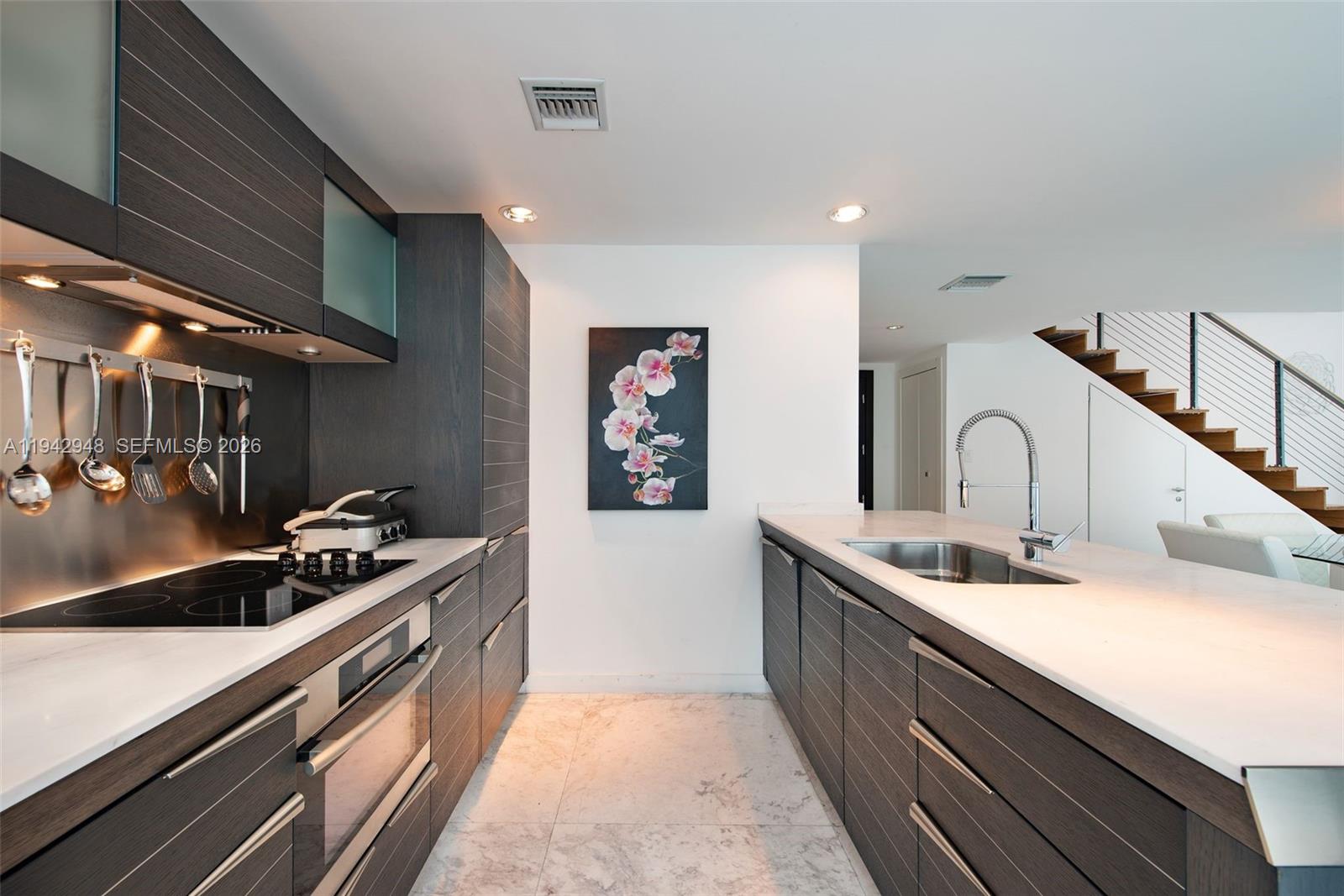 200 Biscayne Blvd Way, Unit 502 Miami, FL 33131 - Photo 12 of 23 a kitchen with sink and cabinets