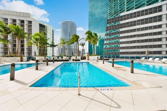 200 Biscayne Blvd Way, Unit 502 Miami, FL 33131 - Photo 21 of 23 a view of a swimming pool with a lounge chairs