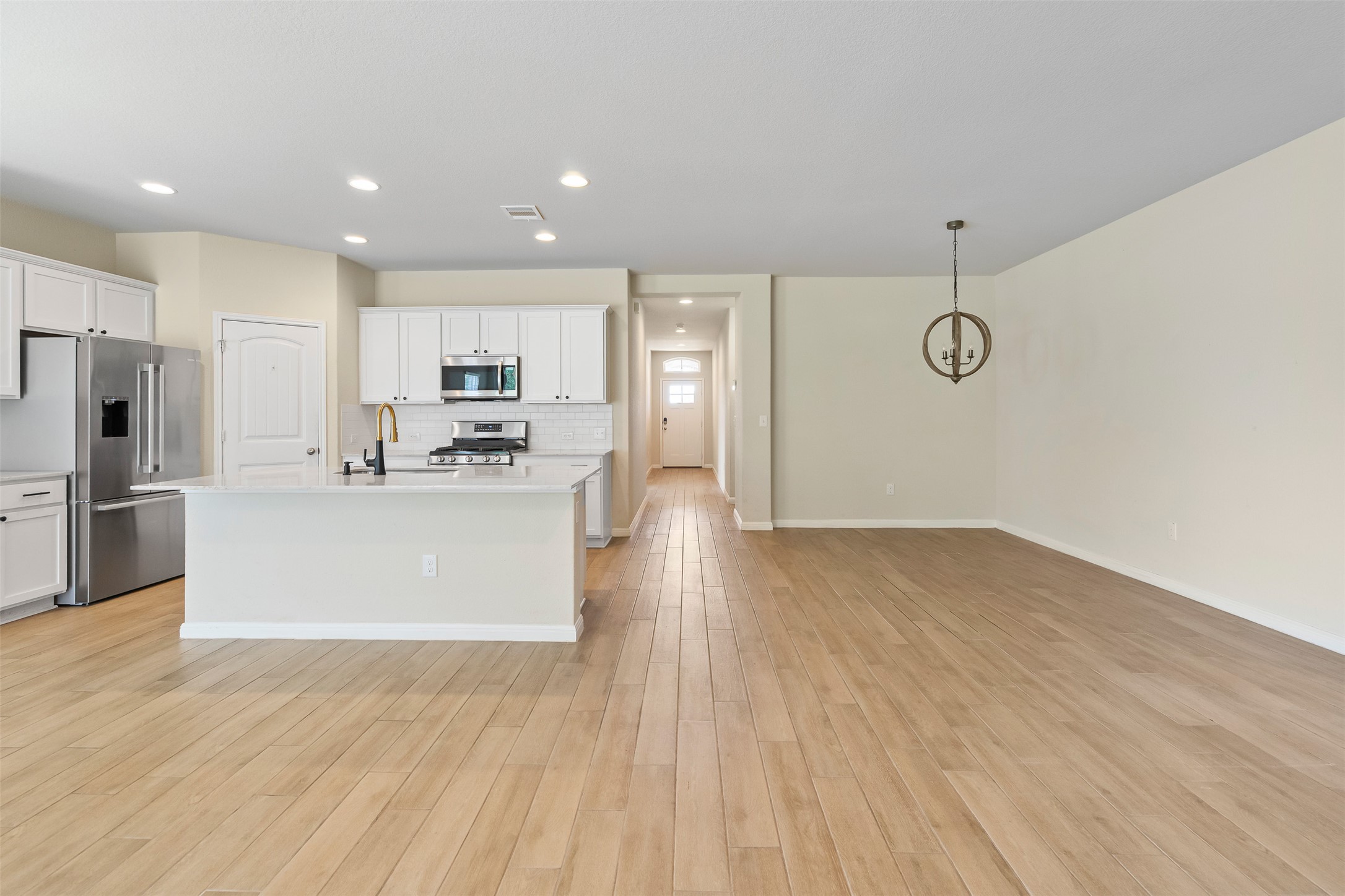 4125 Buffalo Ford Road Georgetown, TX 78628 - Photo 6 of 28 Kitchen with stainless steel appliances, light countertops, backsplash, white cabinets, and recessed lighting