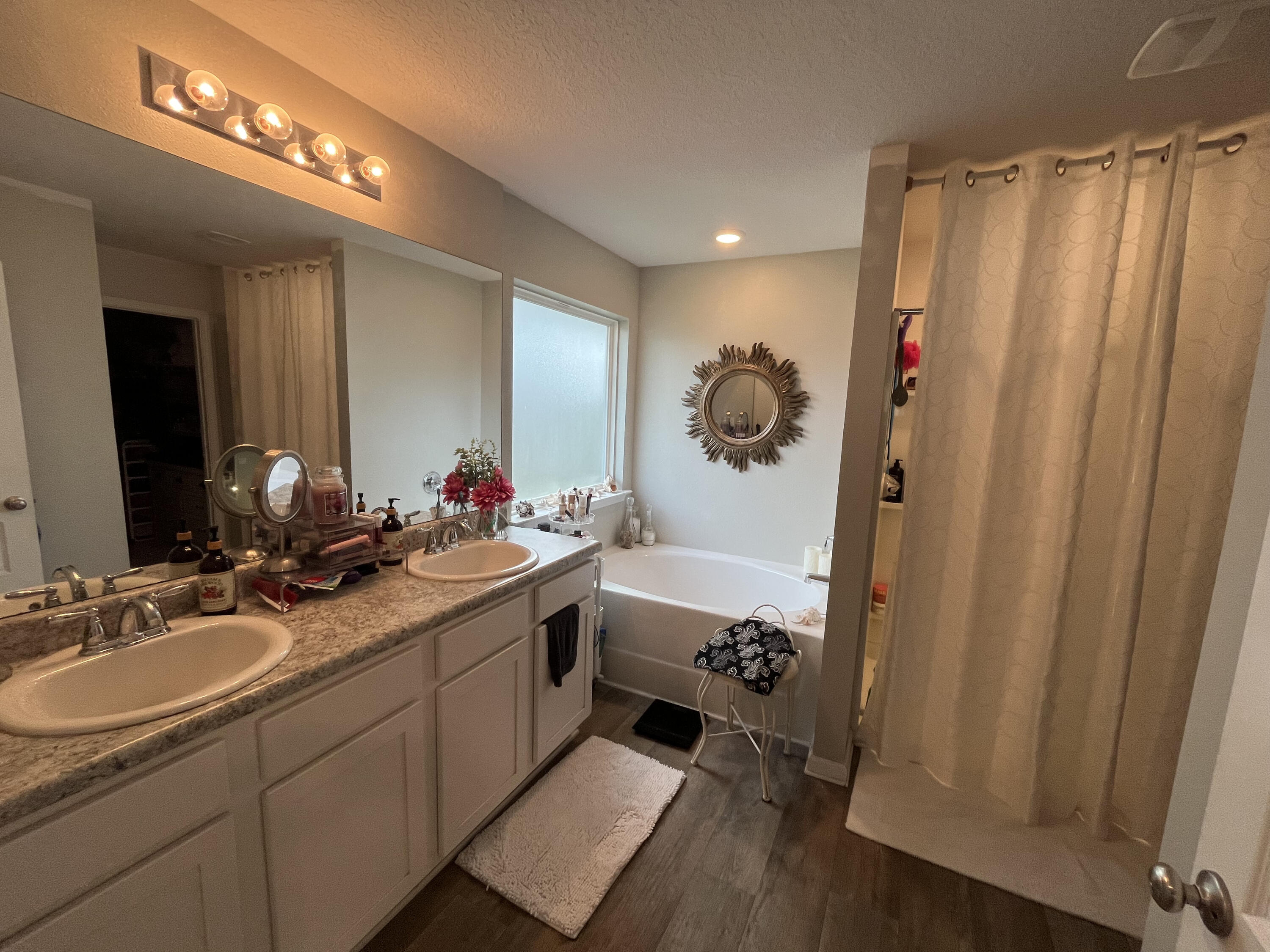 203 This Way Freeport, FL 32439 - Photo 15 of 29 a bathroom with 2 sink tub and a mirror