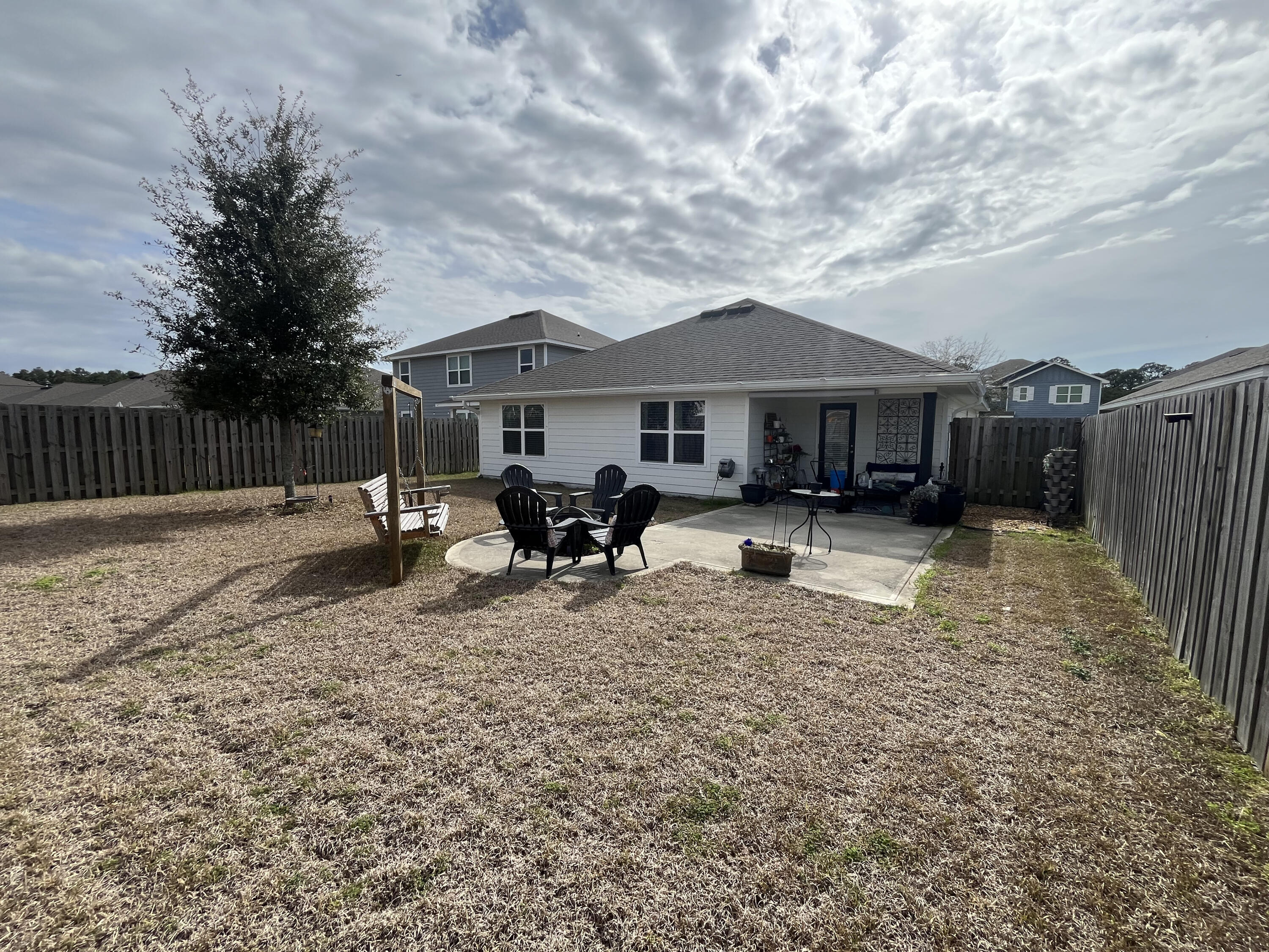 203 This Way Freeport, FL 32439 - Photo 2 of 29 a backyard of a house with table and chairs