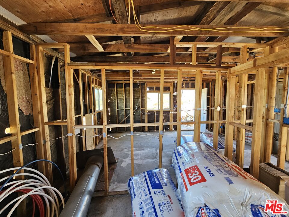7797 Quartz Road Mojave, CA 93501 - Photo 26 of 49 a view of a porch with wooden floor and furniture