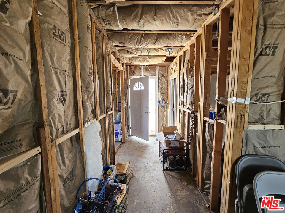 7797 Quartz Road Mojave, CA 93501 - Photo 37 of 49 a view of walk in closet with clothes and shoes
