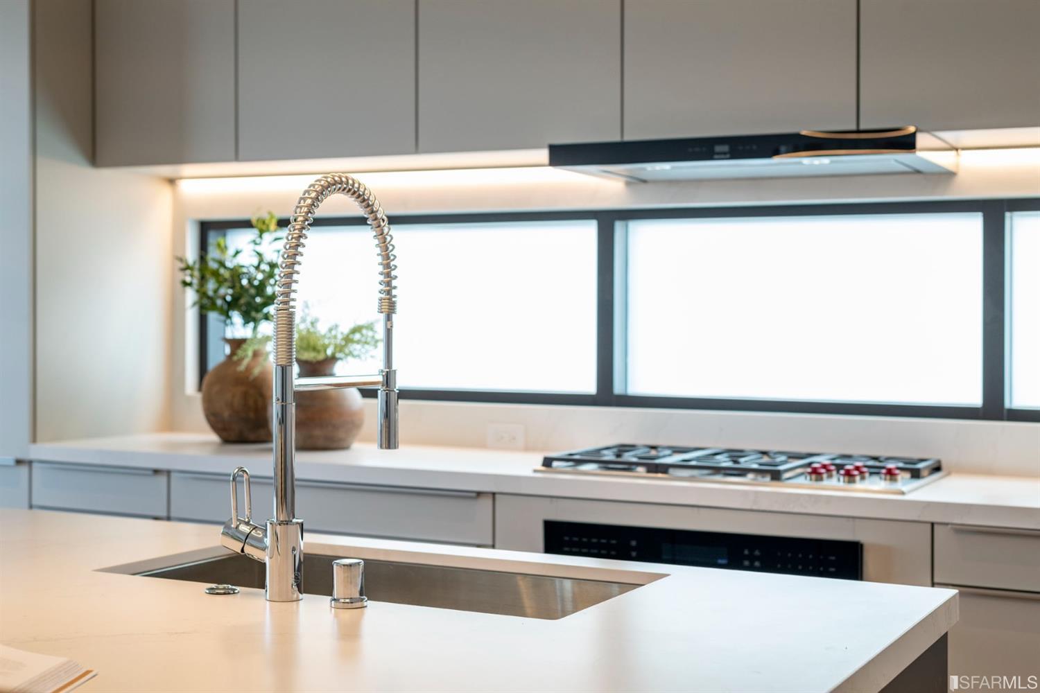 1805 Buchanan Street, Unit 3B San Francisco, CA 94115 - Photo 15 of 55 a view with kitchen island a stove and a sink
