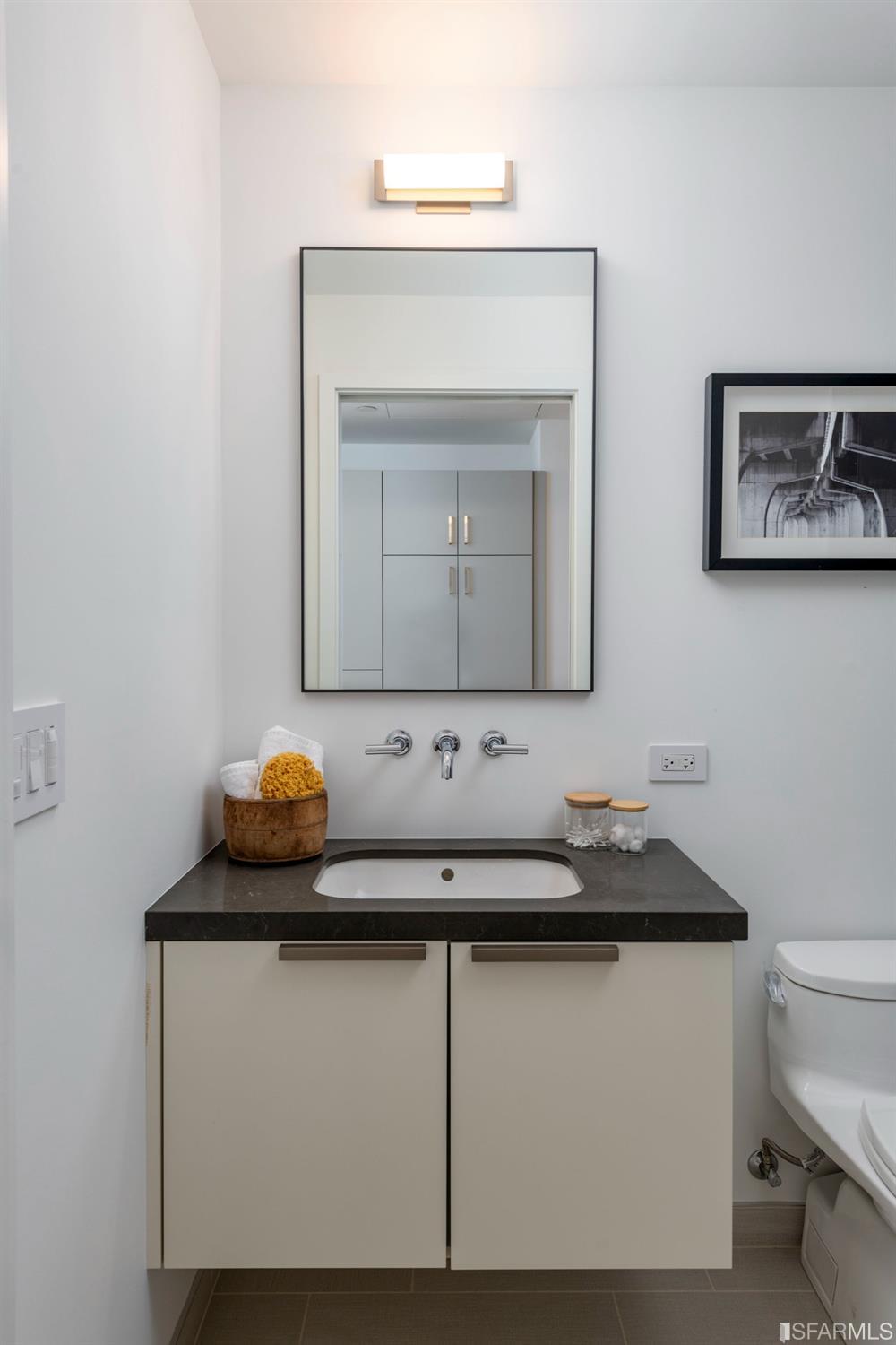 1805 Buchanan Street, Unit 3B San Francisco, CA 94115 - Photo 27 of 55 a bathroom with a toilet sink and mirror