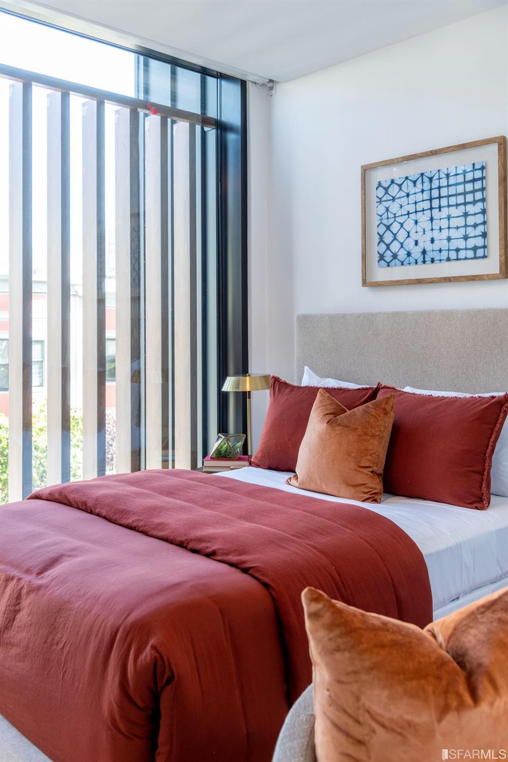 1805 Buchanan Street, Unit 3B San Francisco, CA 94115 - Photo 30 of 55 a large bed sitting in a bedroom next to a window