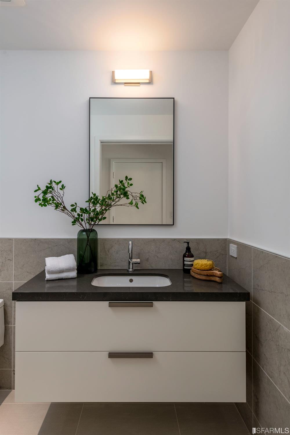 1805 Buchanan Street, Unit 3B San Francisco, CA 94115 - Photo 31 of 55 a bathroom with a sink and a mirror