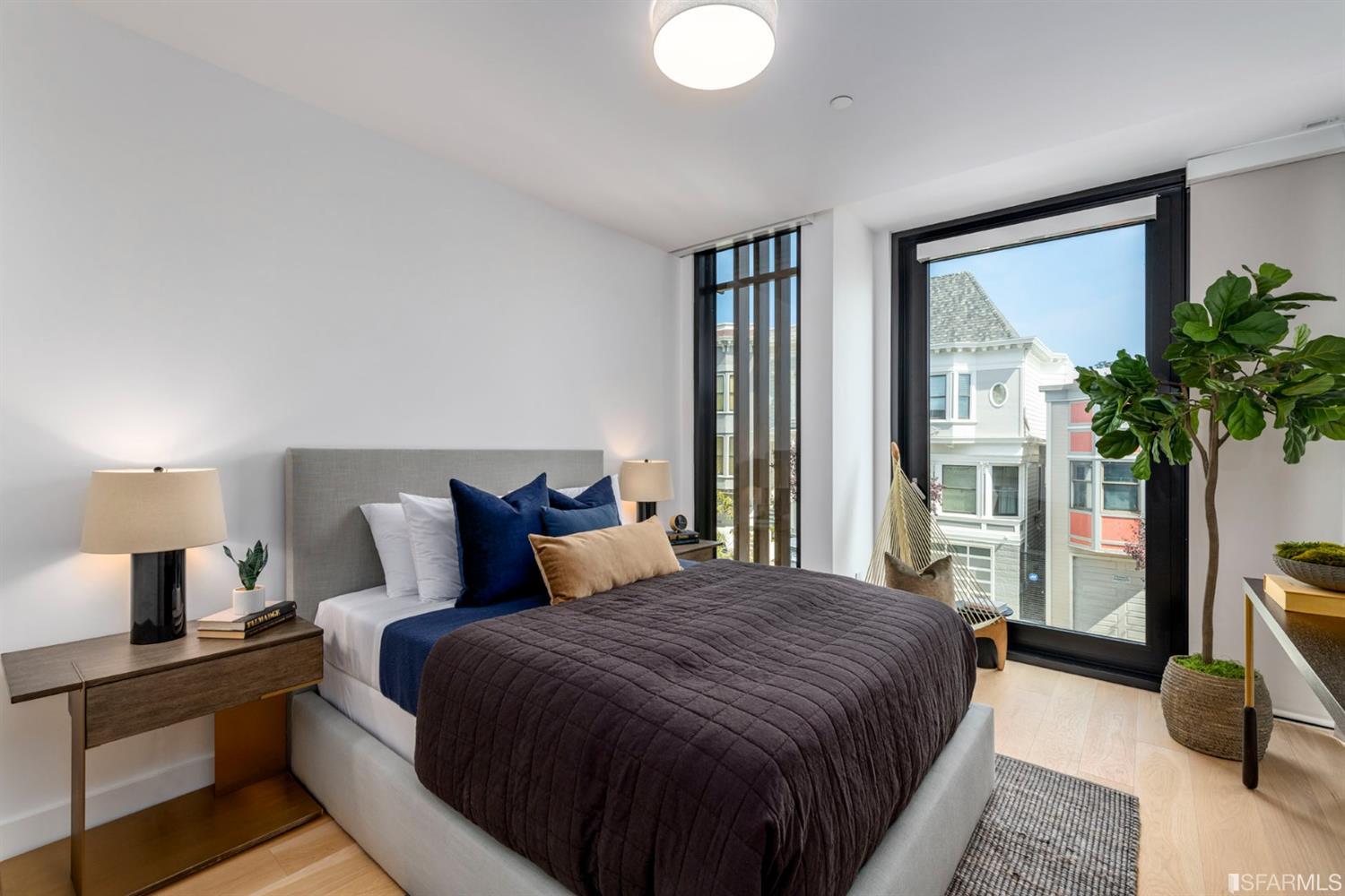 1805 Buchanan Street, Unit 3B San Francisco, CA 94115 - Photo 36 of 55 a bedroom with a large bed and a potted plant